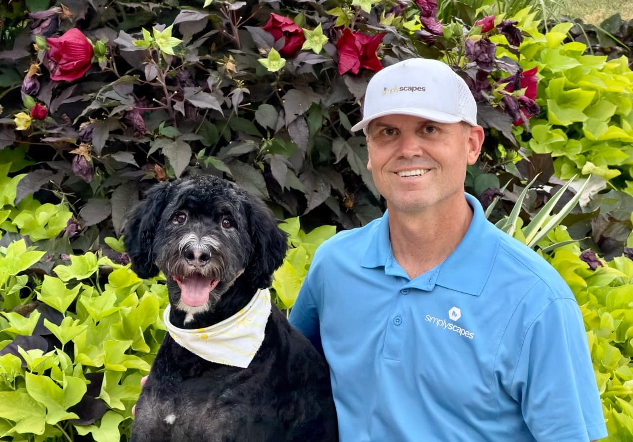 Scott Brady, the SimplyScapes founder, with his dog Milo in the Utah mountains
