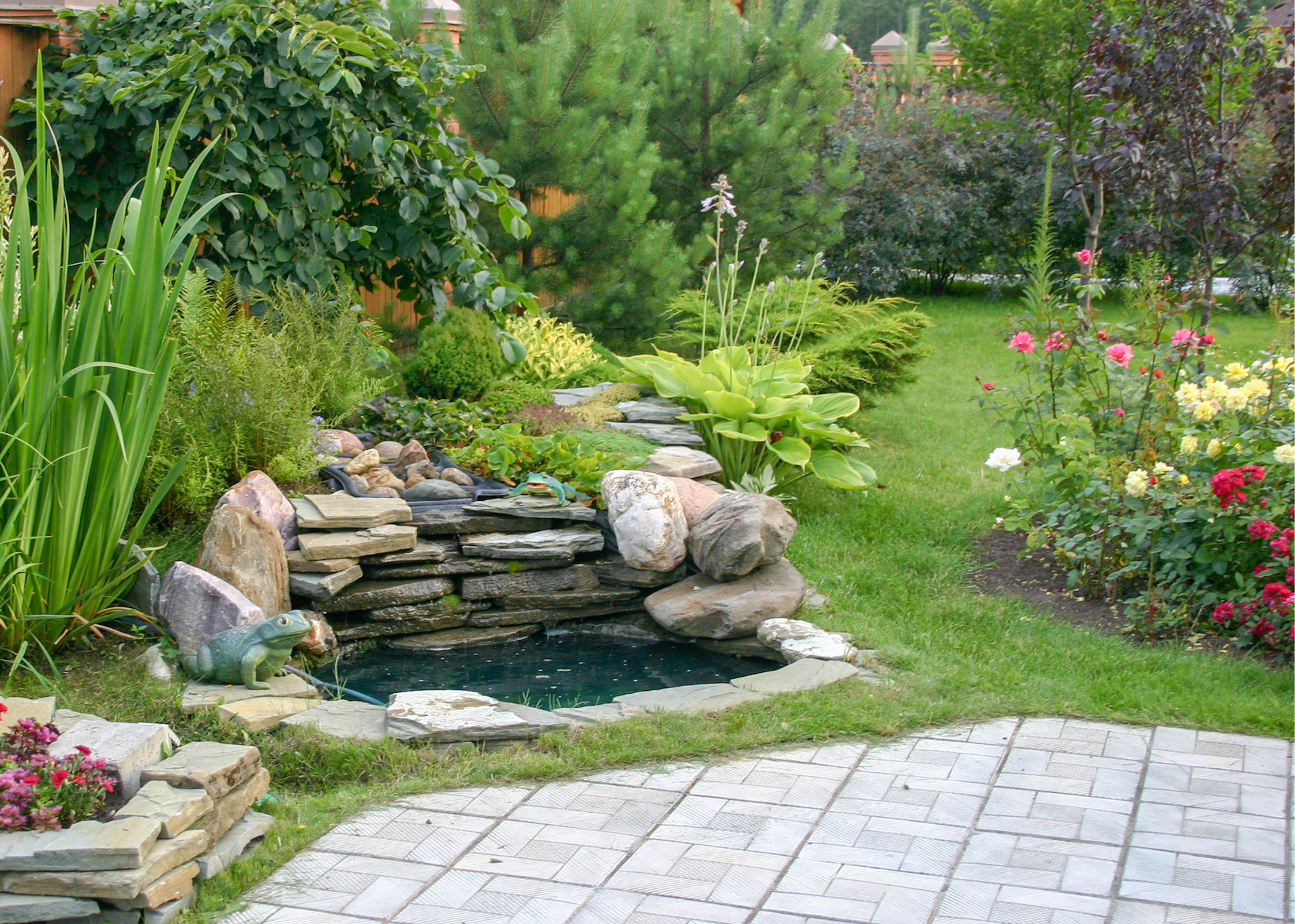 Backyard with patio, pond and plant combos