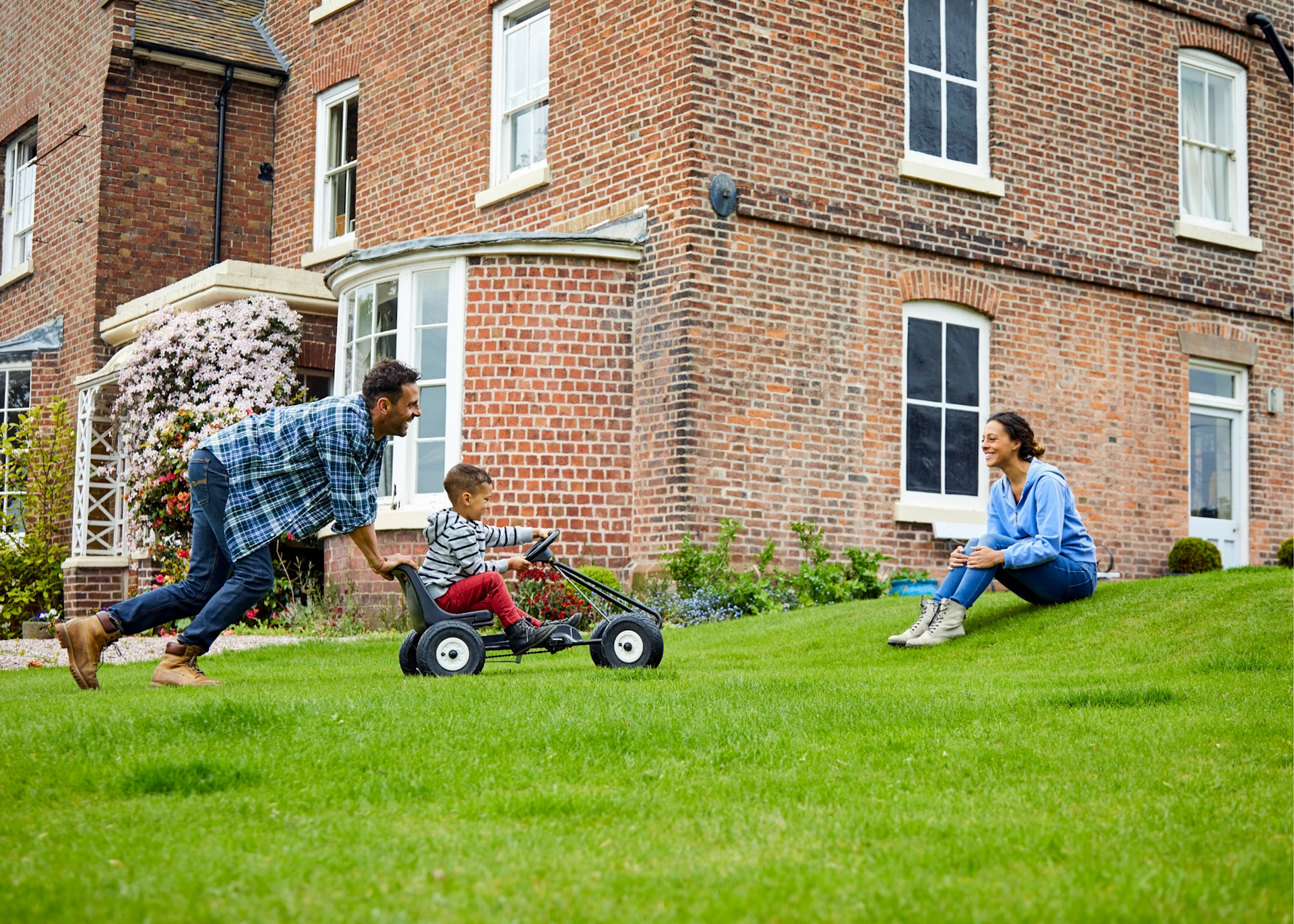 Family playing outside on grass