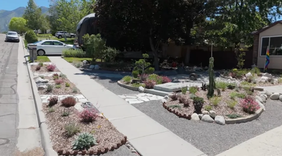 Flowering planting islands and stone steps connect the sidewalk to the Japanese-inspired front garden